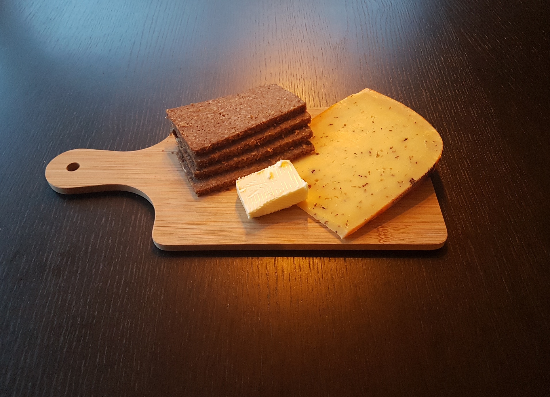 butter, Frisian rye bread and Frisian Clove Cheese on a wooden board